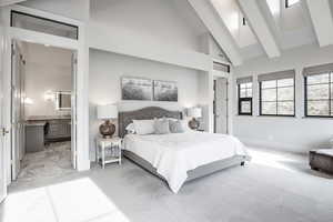 Bedroom featuring baseboards, connected bathroom, light colored carpet, beamed ceiling, and high vaulted ceiling