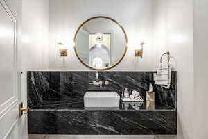 Bathroom featuring a sink and decorative backsplash