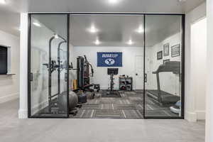 Exercise room featuring carpet and baseboards