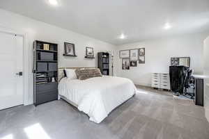 Bedroom with light carpet, baseboards, and recessed lighting