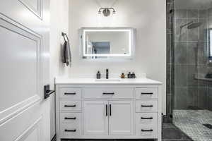 Full bathroom featuring a shower stall and vanity