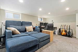 Carpeted living room with baseboards and recessed lighting