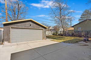 Detached garage featuring fence