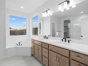 Full bath featuring a garden tub, tile patterned floors, a sink, and double vanity