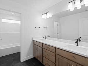 Full bathroom featuring tile patterned floors, a sink, and double vanity