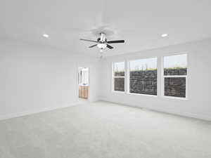 Unfurnished room featuring recessed lighting, light carpet, and baseboards
