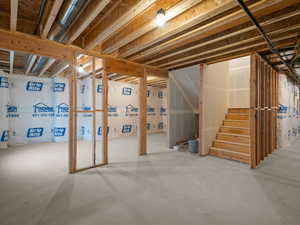 Unfinished below grade area featuring stairs
