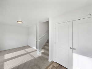 Below grade area with stairway and baseboards