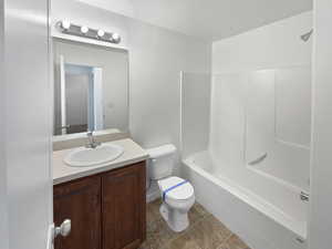 Full bath with toilet,  shower combination, and vanity