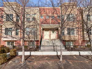 View of property with brick siding