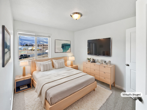 Bedroom with light carpet and baseboards