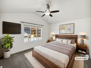 Bedroom featuring vaulted ceiling, carpet, a ceiling fan, and baseboards