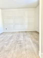 Unfurnished room with baseboards and a decorative wall