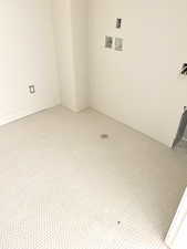 Spare room with baseboards and light colored carpet