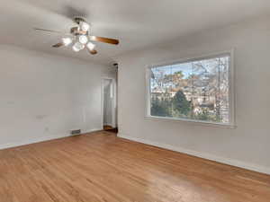 Unfurnished living room with baseboards, visible vents, and light wood finished floors