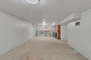 Spare room featuring a textured ceiling and carpet