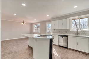 Kitchen with a sink, visible vents, ornamental molding, appliances with stainless steel finishes, and backsplash