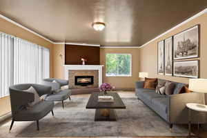 Living area with ornamental molding and a glass covered fireplace