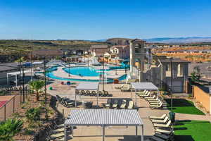 Pool with fence, a mountain view, and a water slide