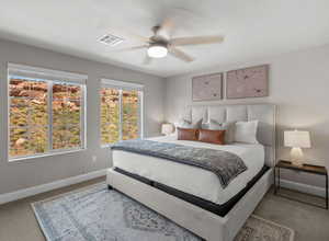 Carpeted bedroom with a ceiling fan, visible vents, and baseboards