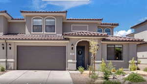 Mediterranean / spanish-style house featuring concrete driveway, a tile roof, an attached garage, and stucco siding