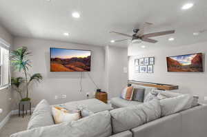 Living area featuring recessed lighting, light carpet, and a textured ceiling