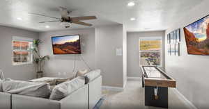 Cinema featuring baseboards, a ceiling fan, carpet, a textured ceiling, and recessed lighting