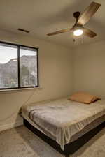 Bedroom featuring baseboards, ceiling fan, visible vents, and carpet flooring