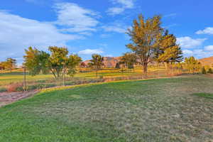 View of yard with fence, a mountain view, and a rural view