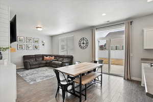 Dining area, baseboards, and wood finished floors