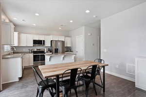 Dining area featuring recessed lighting, dark wood finished floors, and baseboards