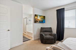 Bedroom featuring carpet flooring and baseboards