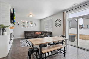 Dining area, baseboards, and wood finished floors