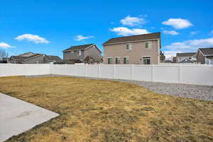 View of yard with a fenced backyard and a residential view