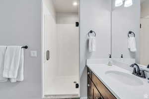 Bathroom with a stall shower and vanity