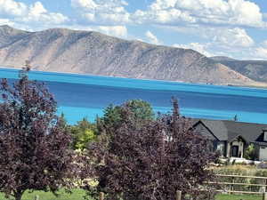 View of property exterior featuring a water and mountain view
