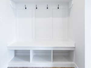 Mudroom with baseboards and wood finished floors