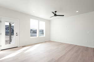 Spare room with light wood-type flooring, visible vents, baseboards, and recessed lighting