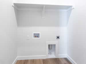 Laundry room featuring laundry area, hookup for a washing machine, electric dryer hookup, and wood finished floors