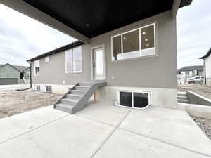 Rear view of house with a residential view and stucco siding