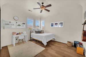 Bedroom featuring visible vents, ceiling fan, baseboards, and wood finished floors