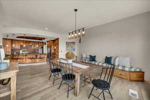 Dining space with recessed lighting, visible vents, and light wood finished floors