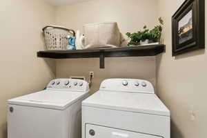 Laundry room featuring washing machine and dryer and laundry area