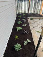 View of yard featuring a garden and fence