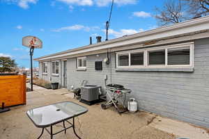 Back of property with a patio area and central air condition unit