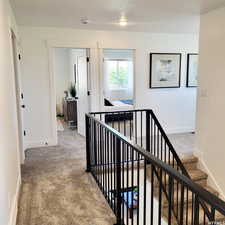 Hallway featuring carpet and baseboards