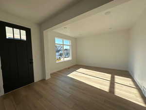 Entrance foyer featuring wood finished floors and baseboards