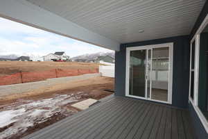 Wooden terrace featuring fence and a mountain view