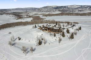 Snowy aerial view featuring a mountain view