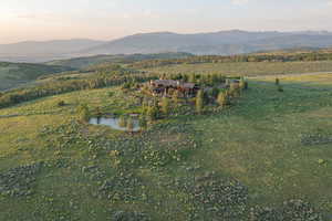 Aerial overview of property's location with a water and mountain view and rural landscape